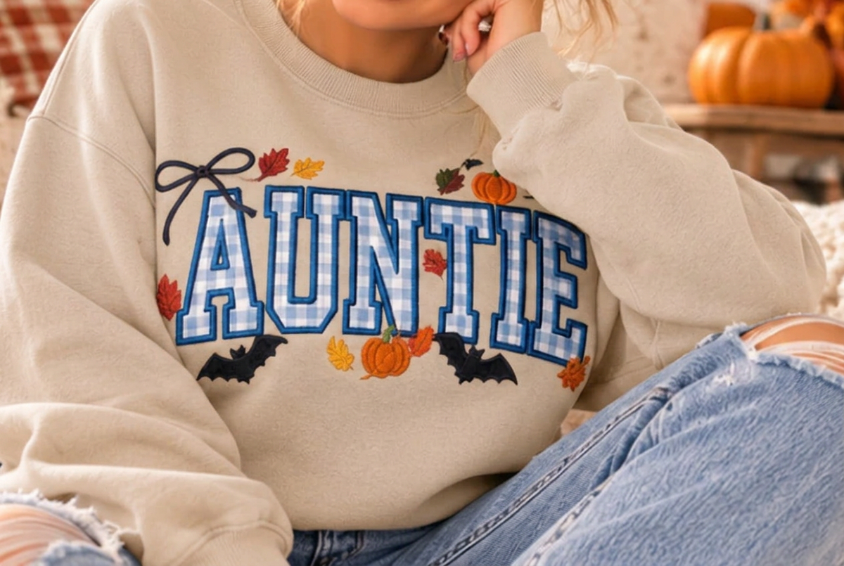 AI-generated Sand crewneck mockup with fall AUNTIE gingham design