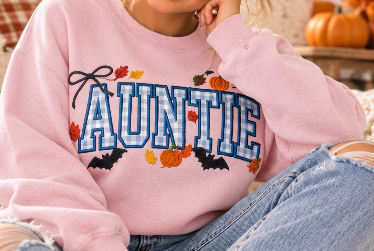 AI-generated Light Pink crewneck mockup with fall AUNTIE gingham design